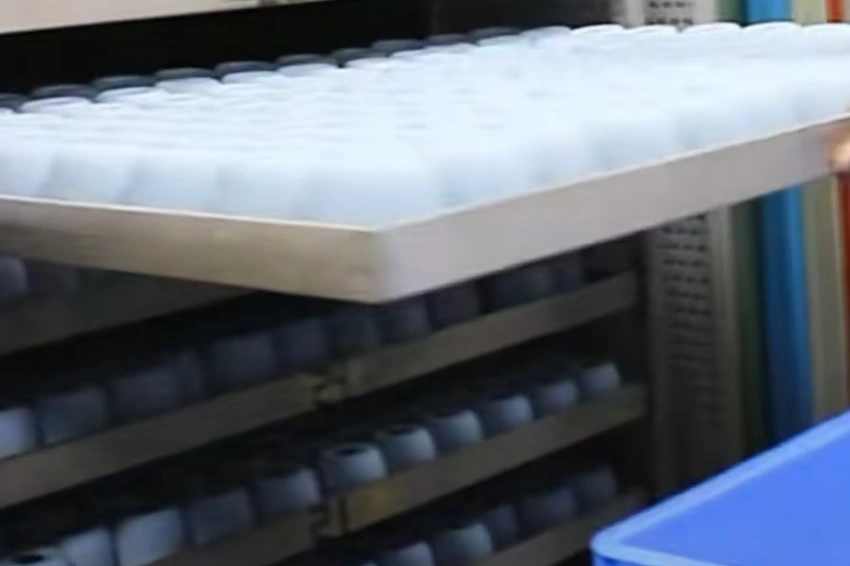 Bulk batch post-curing process by a custom silicone mold manufacturer inside an industrial oven, undergoing extended secondary vulcanization to meet strict European LFGB and FDA food-grade compliance.